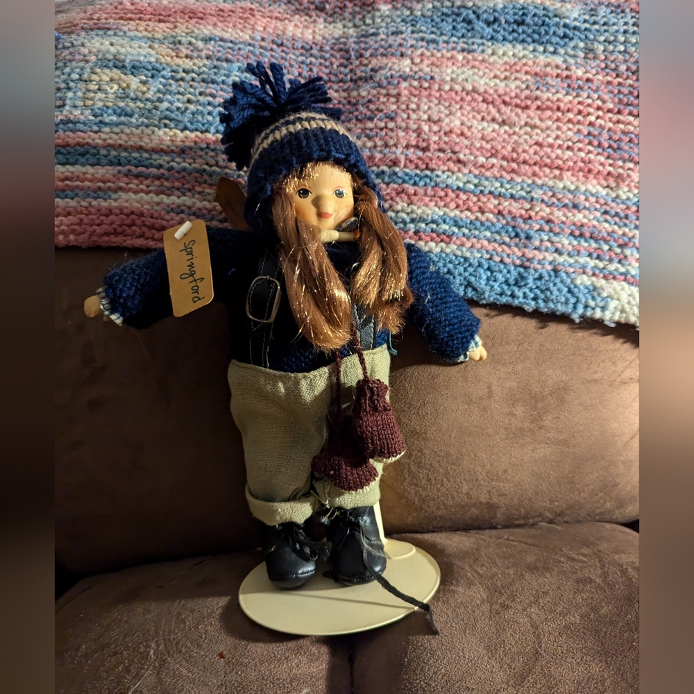 Handcrafted Porcelain Skiing Doll with Blue Outfit, Skis and Stand